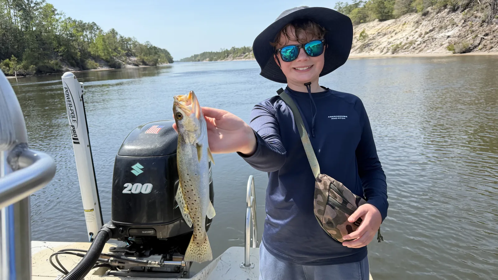 Kid holding speckled trout on Black Creek charter