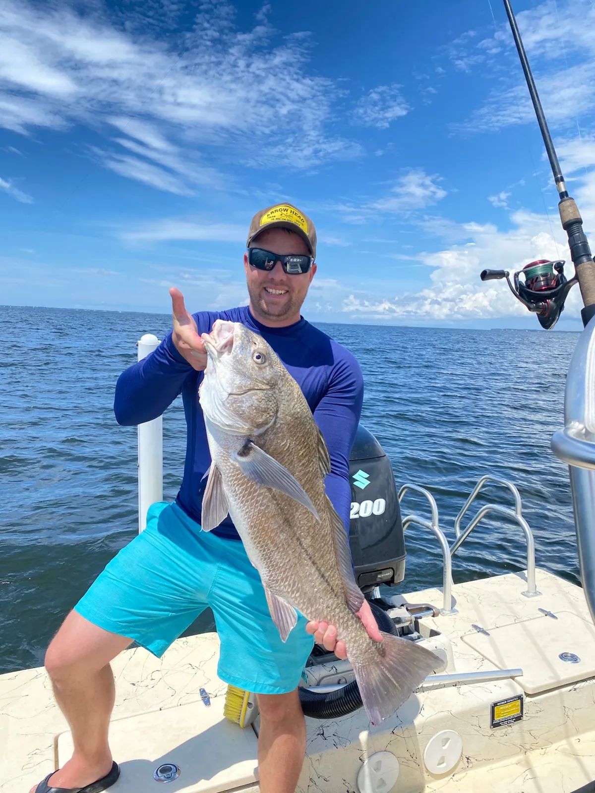 Angler holding black drum on Choctawhatchee Bay charter