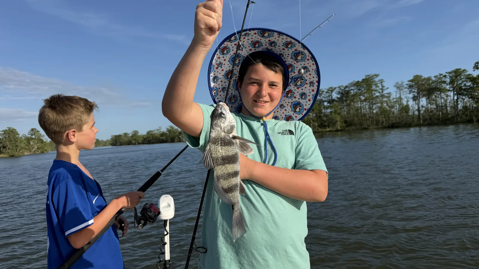 Kid holding sheepshead catch on Choctawhatchee Bay charter