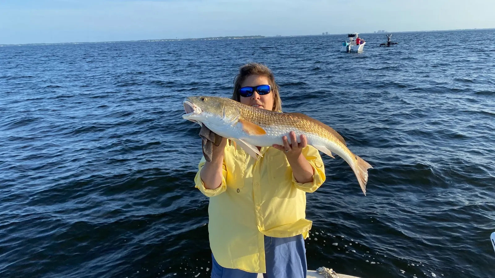 Angler with redfish catch on Choctawhatchee Bay